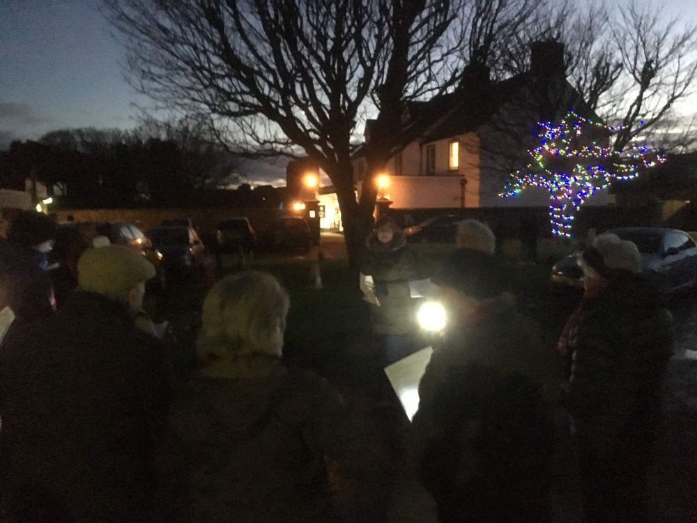 Carol singing in the village square, Holy Island: December 2019
